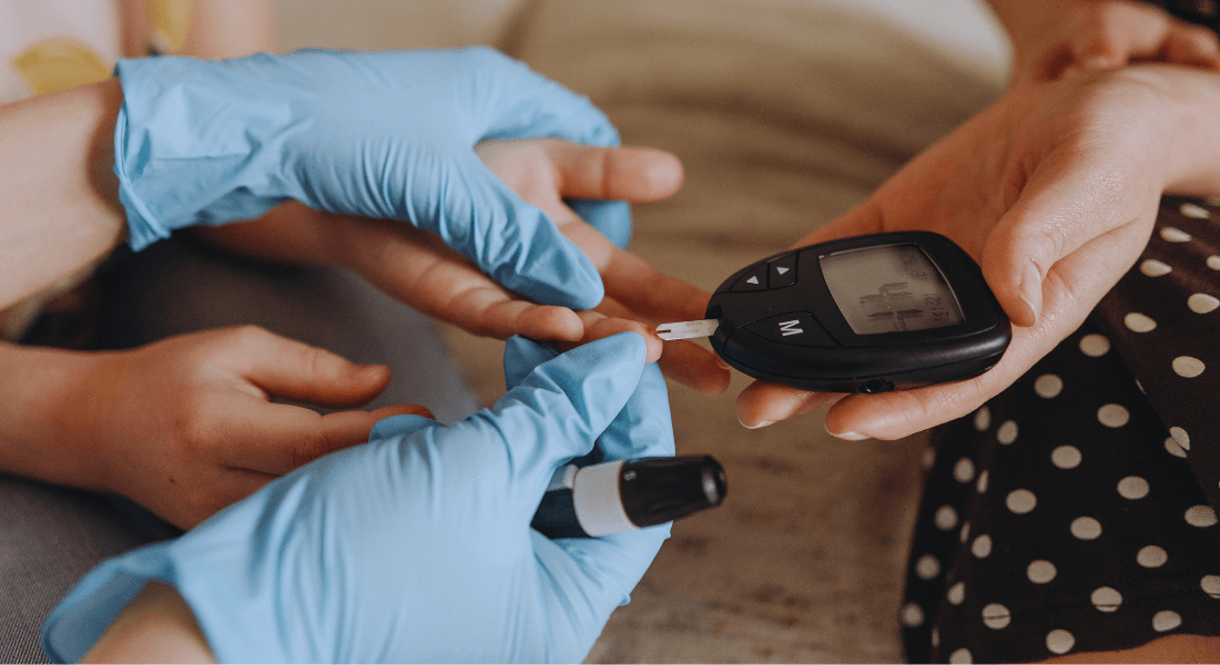 Image of person measuring blood sugar in a patient Image of person measuring blood sugar in a patient