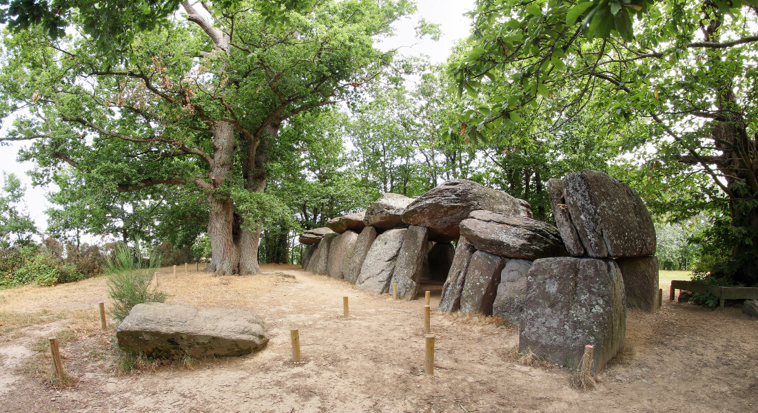 Ancient burial site with large rocks surrounded by trees